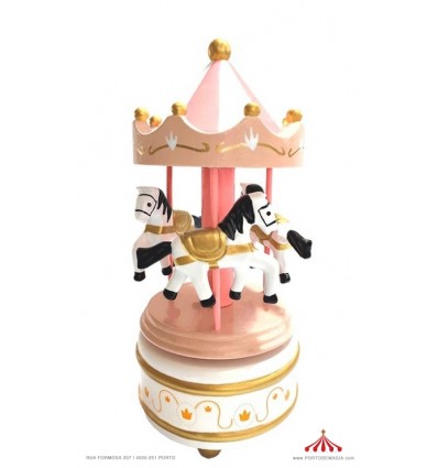 Pink wooden carousel with pink-white roof with music box